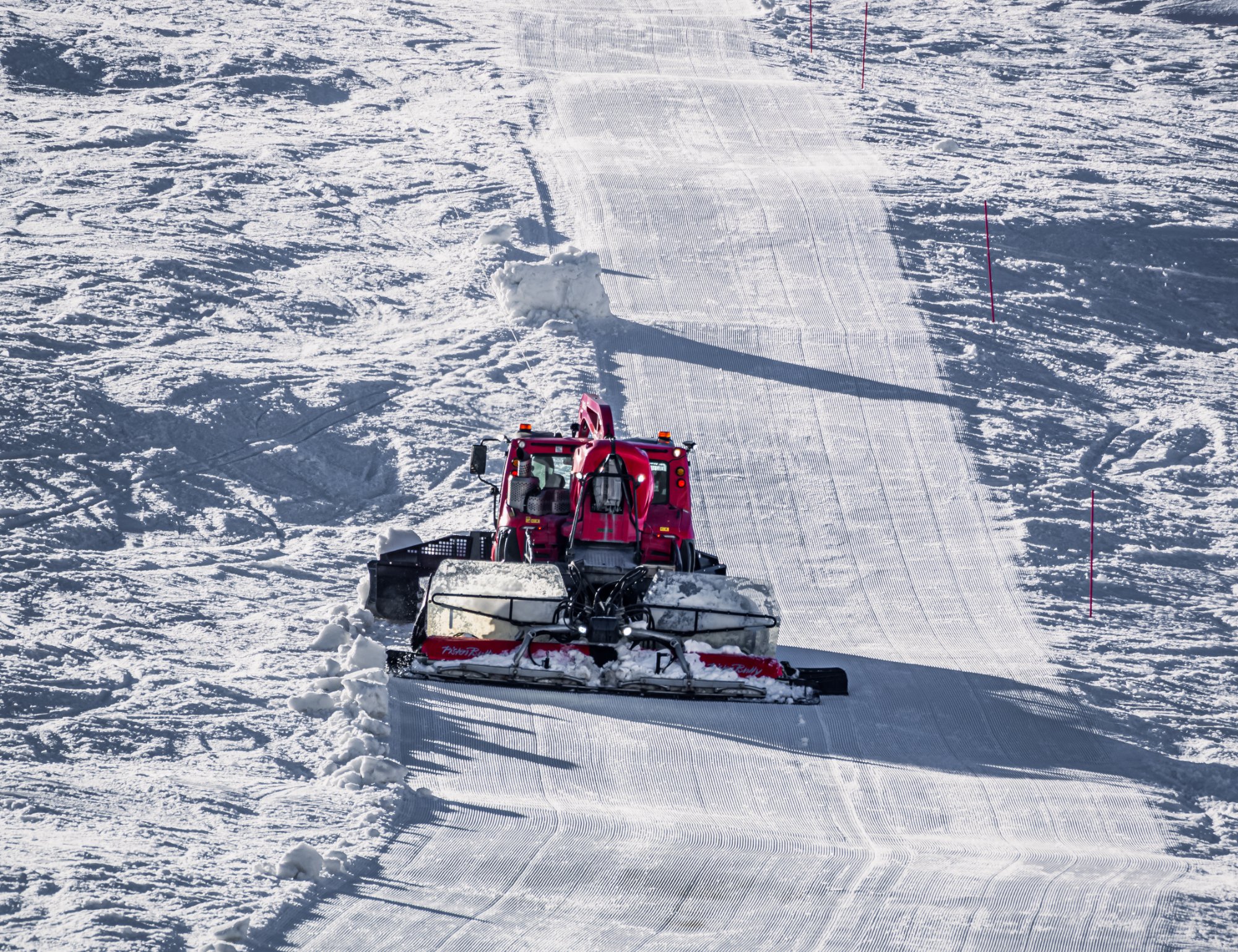 Snow groomer preparing ski slope